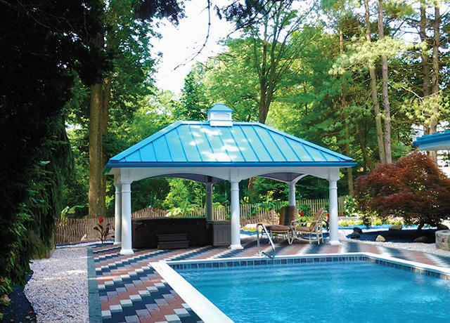 pavilion with a blue roof next to a swimming pool