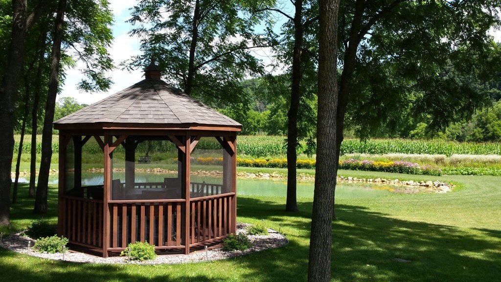 dark wood gazebo by the lake