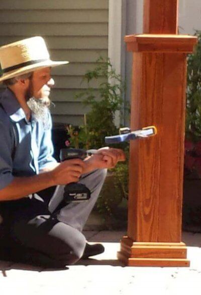 Amish craftsman working on pergola