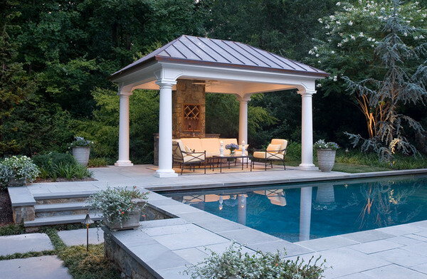 white gazebo pavilion next to a pool with lighting