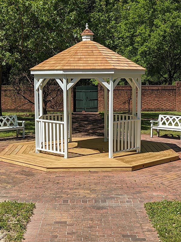 Wood Gazebo in a Box painted white on a wood platform