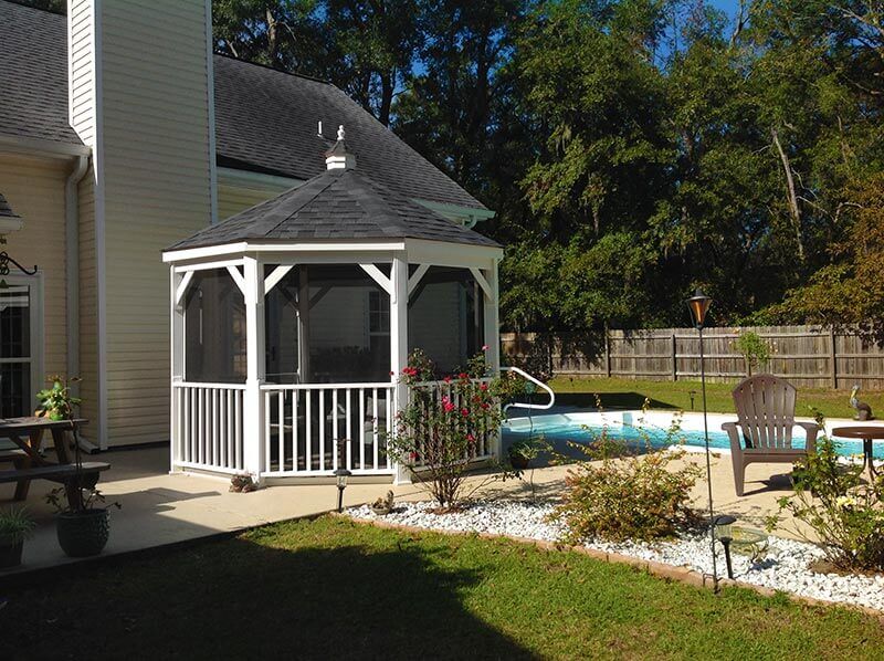 gazebo with screens next to a swimming pool