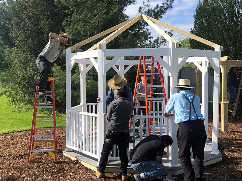 Amish gazebo contractors assembling a gazebo in a box