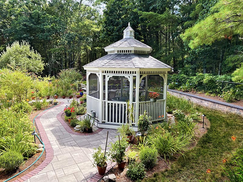 screened oval gazebo in a backyard