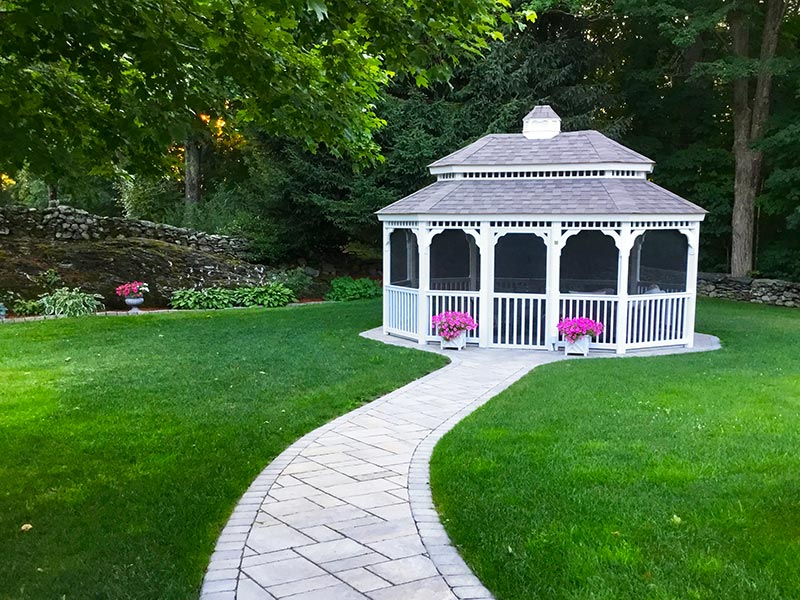 oval gazebo with pagoda roof in a backyard