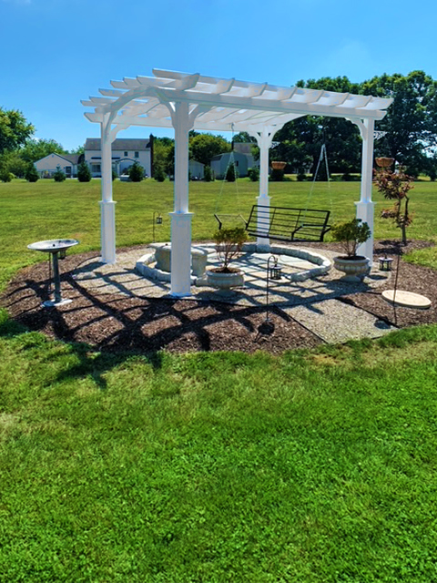 Outdoor pergolas in a backyard with a swing