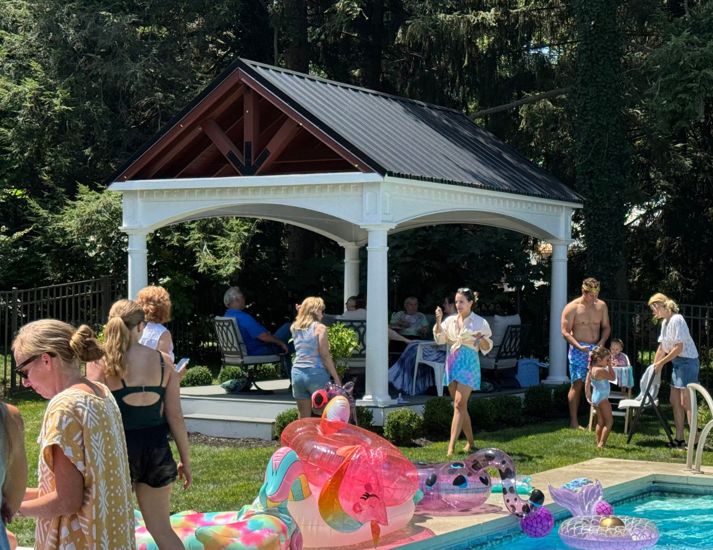 Family enjoying outdoor gathering under vinyl A-frame pavilion